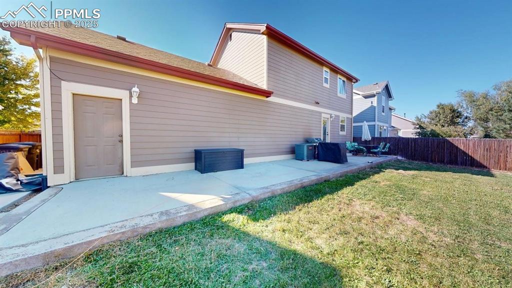 Image 3 of 14: Back of house with a patio area and a shingled roof