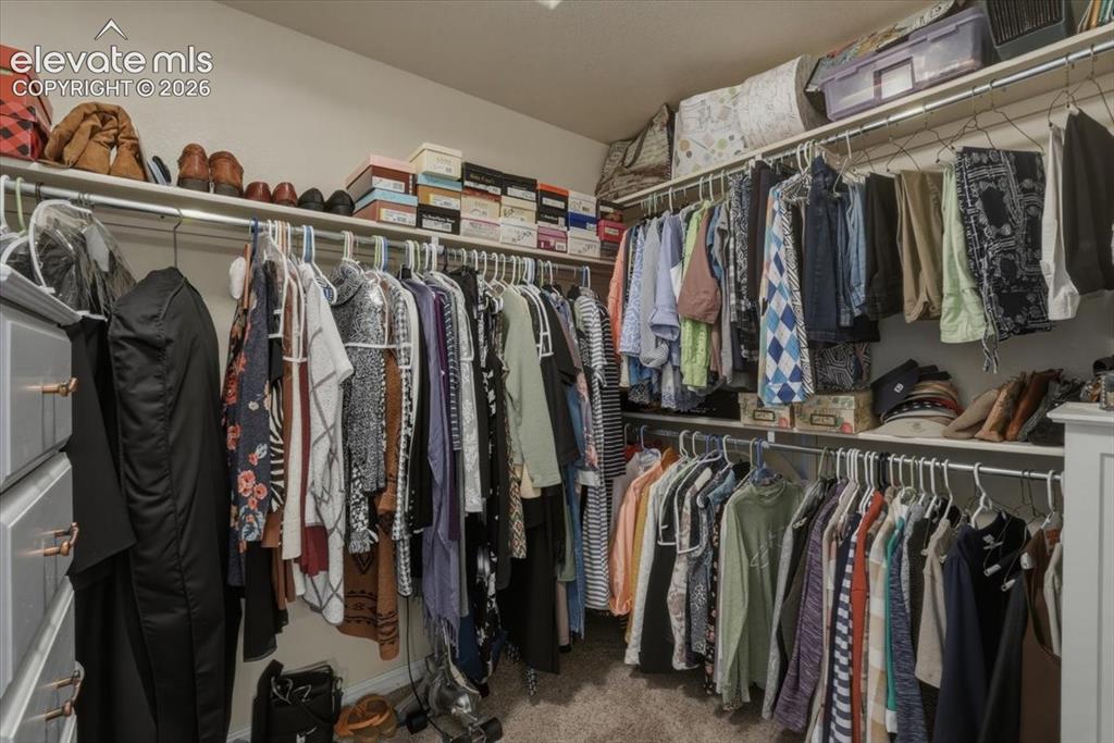 Image 28 of 47: Primary walk-in closet.