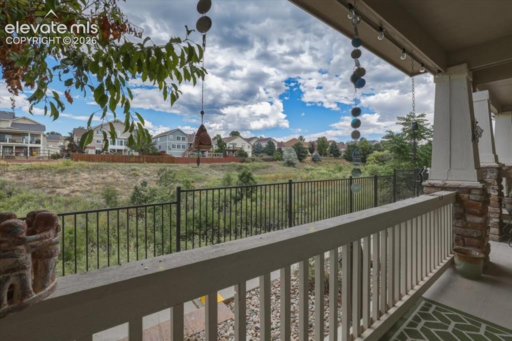 Image 39 of 47: Covered front porch with creek view.