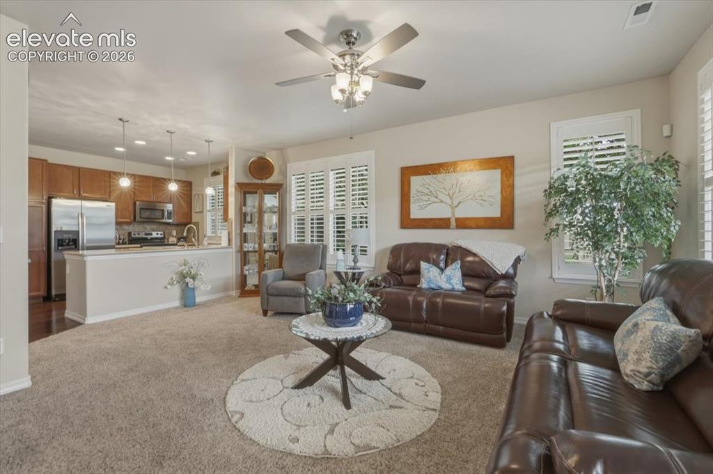 Image 9 of 47: Living room flows nicely into the kitchen.