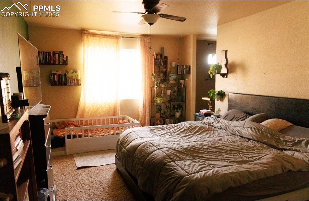 Image 10 of 21: Carpeted bedroom featuring a ceiling fan