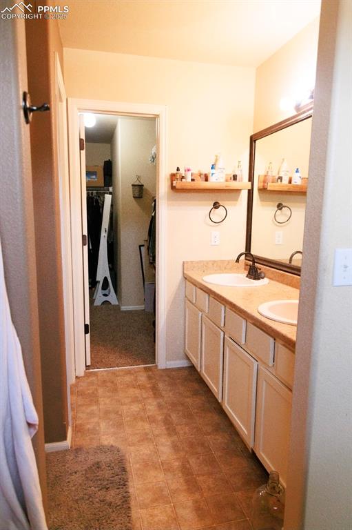 Image 14 of 21: Full bath with double vanity and baseboards