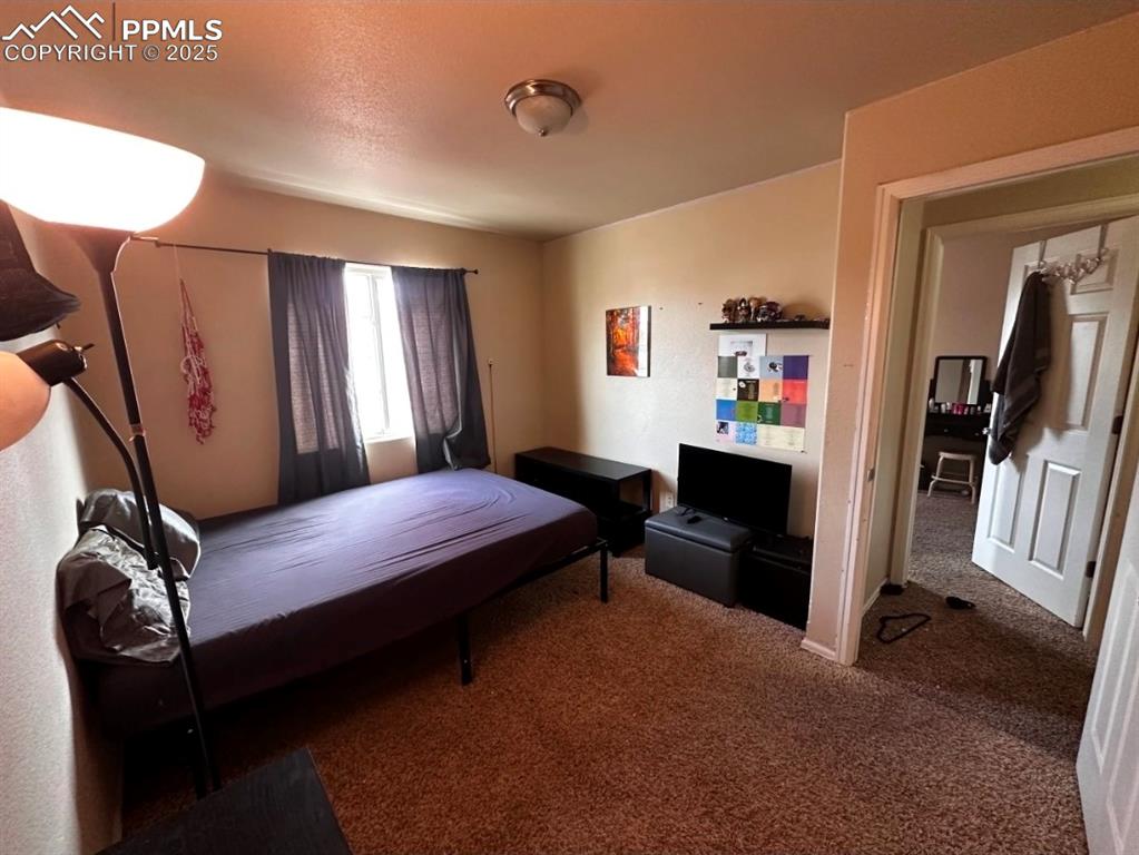 Image 16 of 21: Bedroom with carpet floors