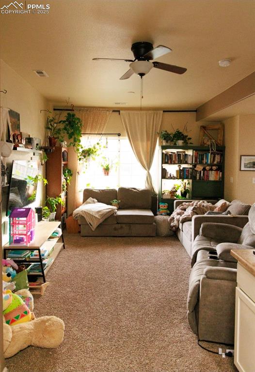 Image 5 of 21: Living room featuring carpet flooring and ceiling fan