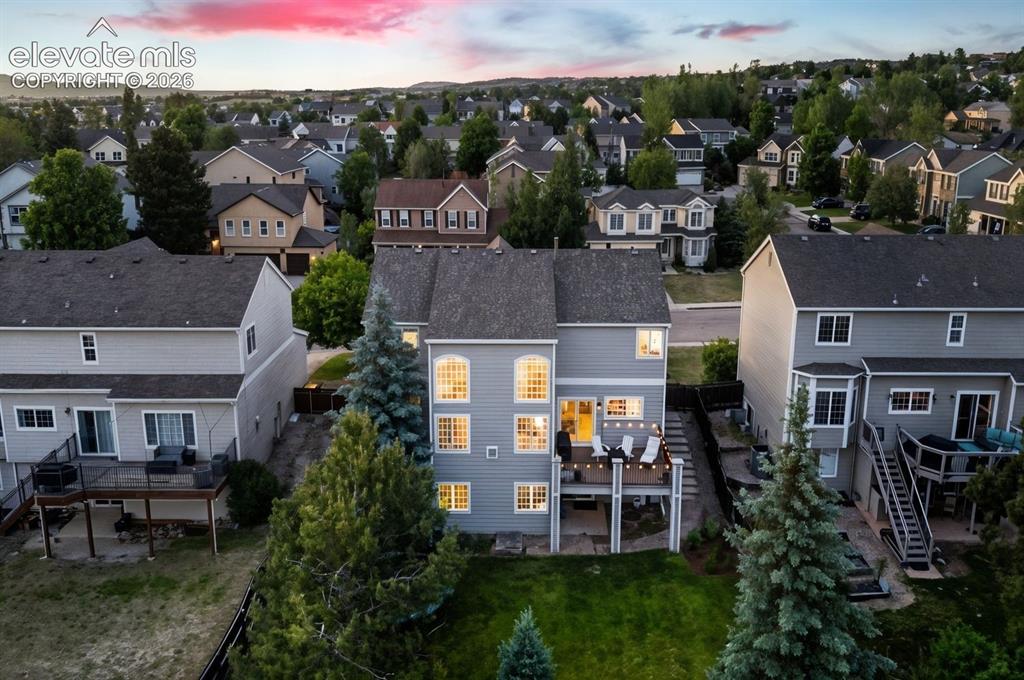 Image 3 of 48: Backyard featuring a spacious deck with built-in lighting, a manicured lawn