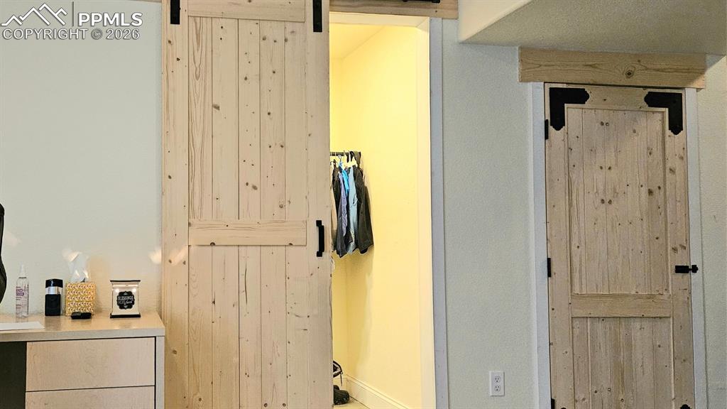 Image 12 of 41: Farmhouse Doors to next photo of Walk-in closet and HVAC Room