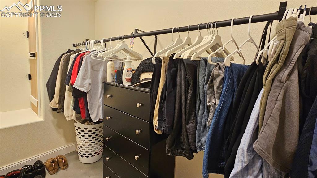 Image 13 of 41: Huge 16x6 Walk in Closet - Sump pump with matching Farmhouse Door, seat for