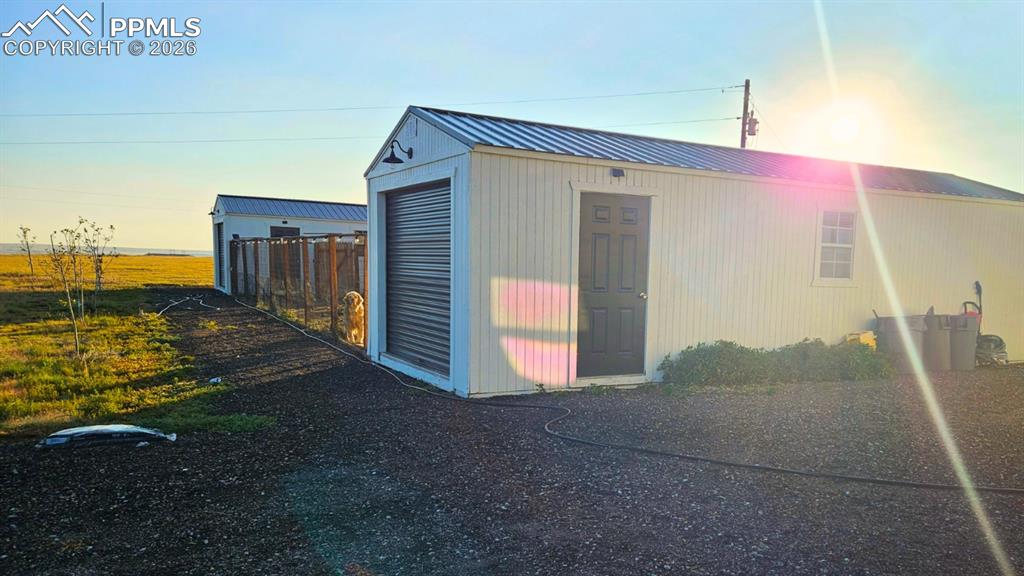 Image 35 of 41: Outbuildings and runs with  amazing grass and sunlight