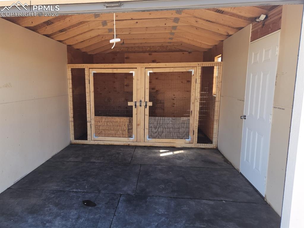 Image 43 of 46: Garage that has been converted to (2) Stalls for Livestock / Dogs