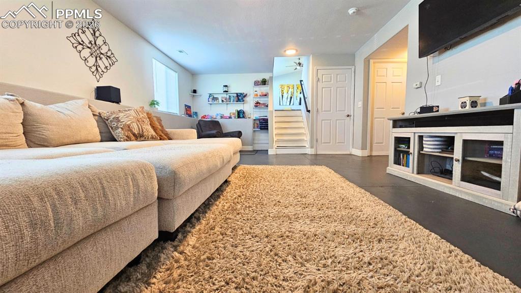 Image 7 of 41: Large Family room with a view to the Main Level. Surround sound, new floor 