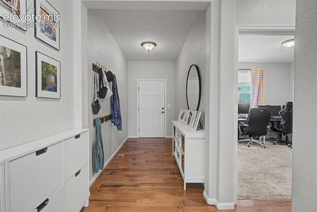 Image 15 of 46: Entry and main level bedroom or office to the right