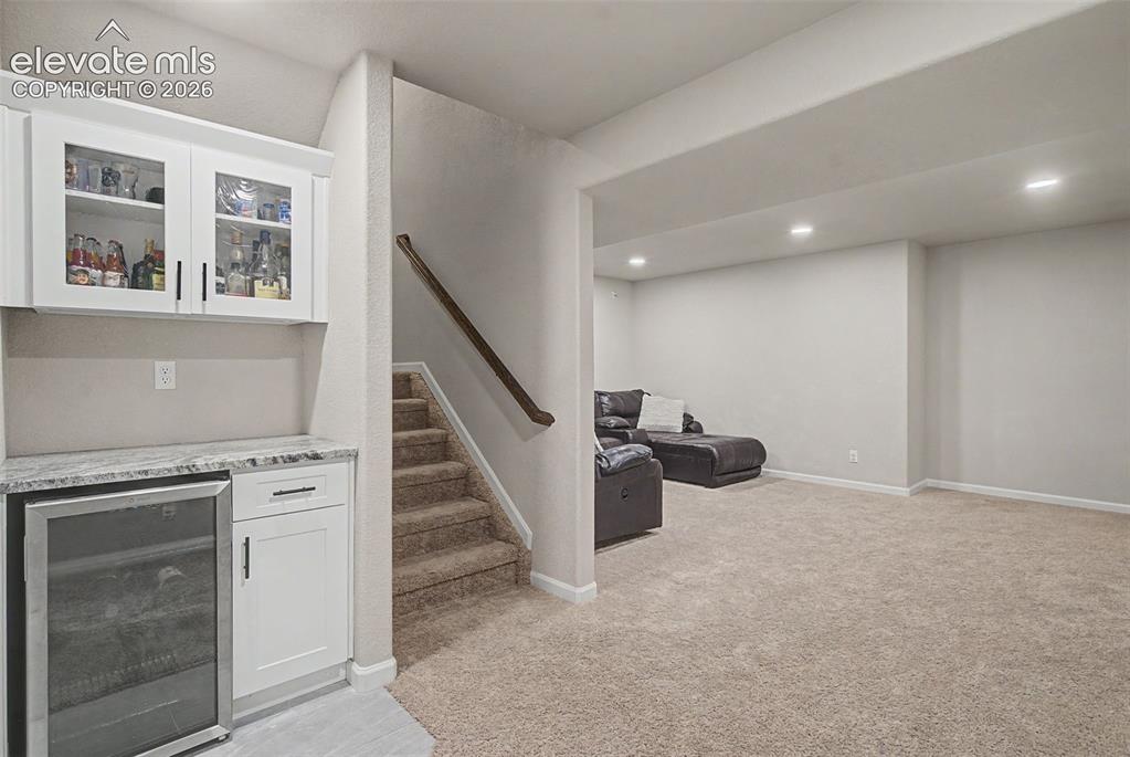 Image 28 of 46: Finished basement with dry bar
