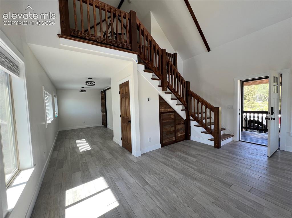 Image 15 of 43: Vaulted ceilings, wood-finish flooring, wood staircase with a matching loft