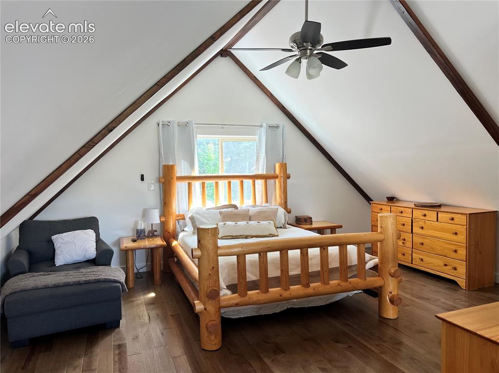 Image 26 of 43: Angled white walls with exposed wood beams