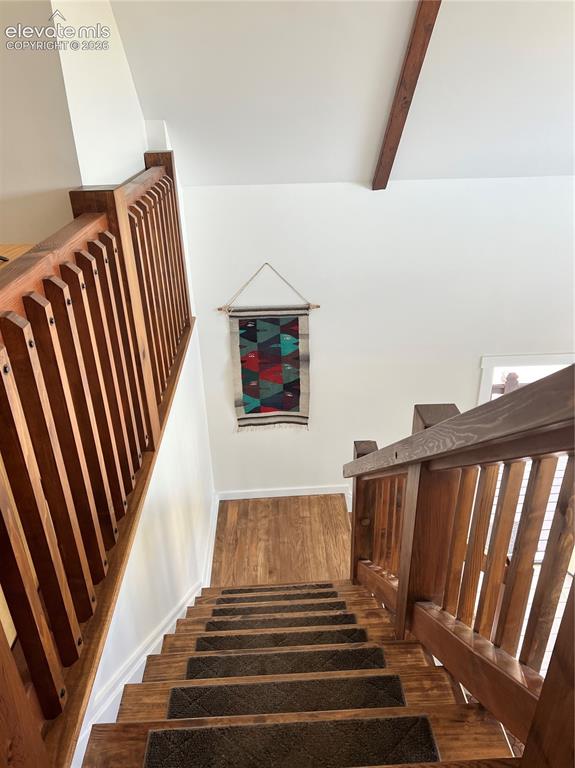 Image 27 of 43: Hardwood staircase with integrated runners, wood-finish flooring, wood rail