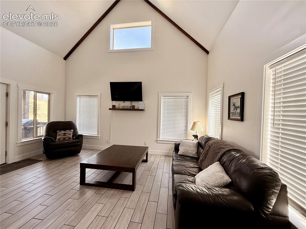 Image 30 of 43: Vaulted ceiling, exposed ceiling beams, upper clerestory window, wood-finis