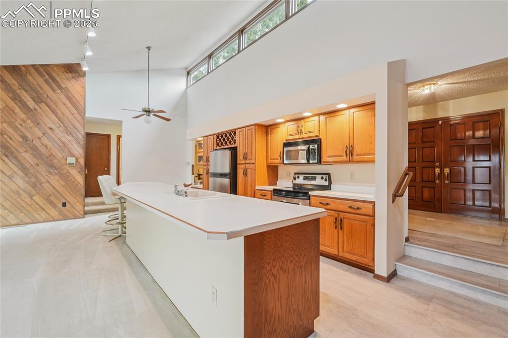 Image 14 of 48: Tons of counter space and breakast bar capability.