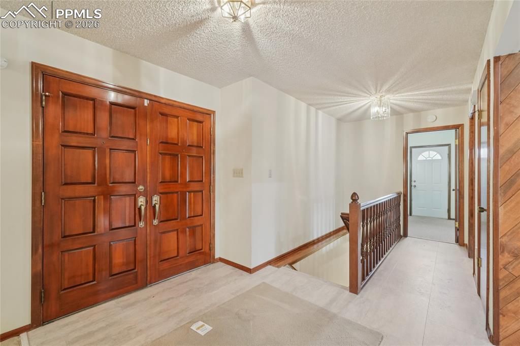 Image 3 of 48: Enter to a foyer that offers a peek at the classic elegance of this home.