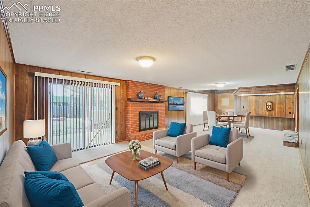 Image 34 of 48: Virtually staged. Downstairs is another fireplace, a large living area and 