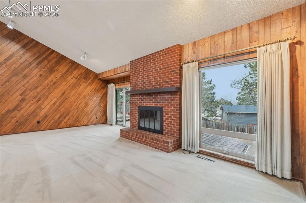 Image 8 of 48: With fireplace and walk-out to the huge deck, feel like you are part of nat