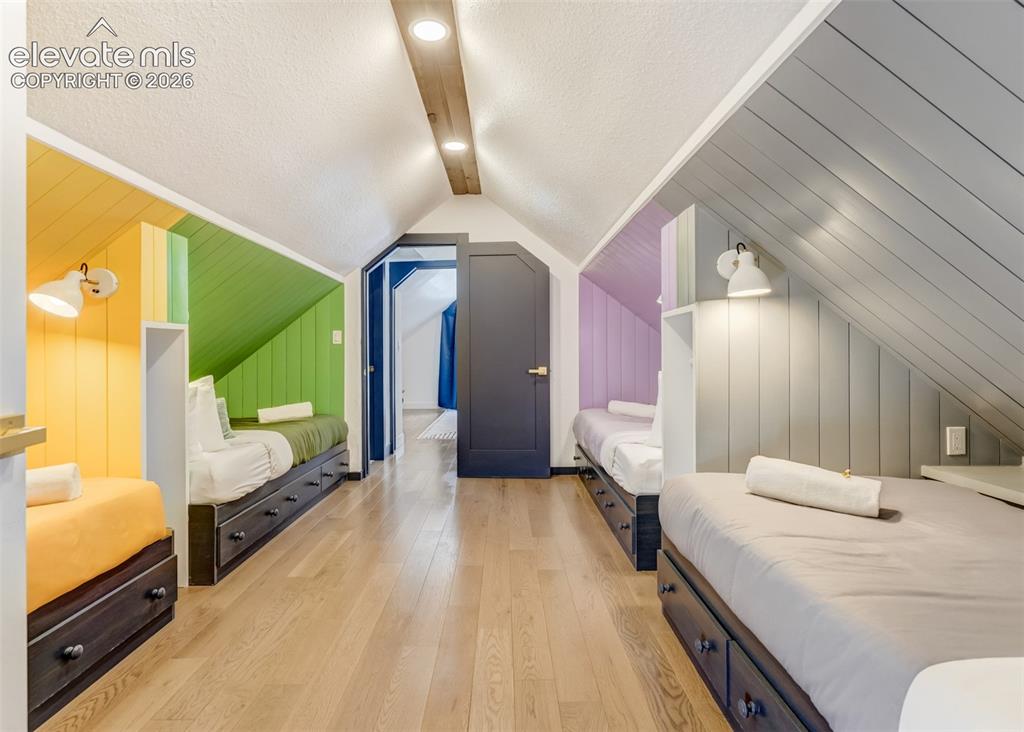 Image 40 of 49: This is a barn style bedroom with sky lighting able to assist in all your s