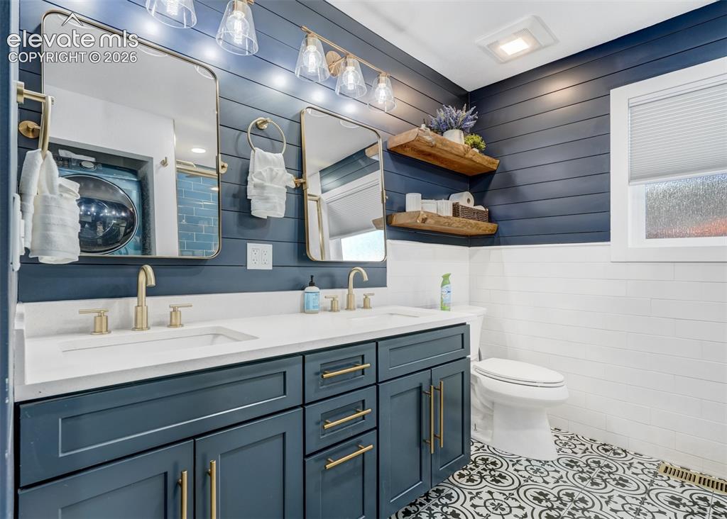 Image 45 of 49: This bathroom has plenty of counter space. Featuing a his and hers sink gre