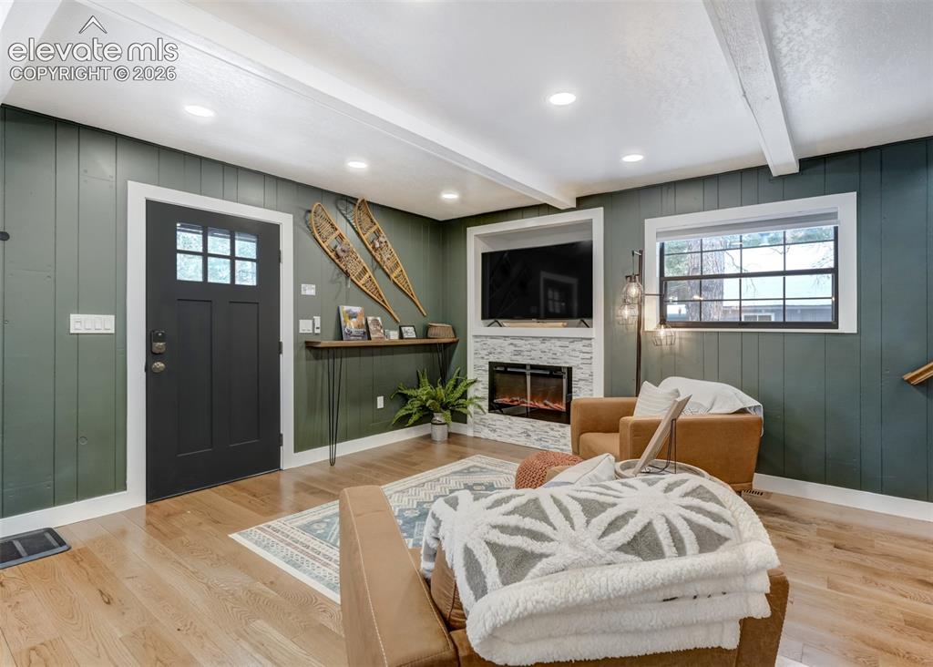 Image 7 of 49: The living room features a electric heating fireplace to enjoy on those col