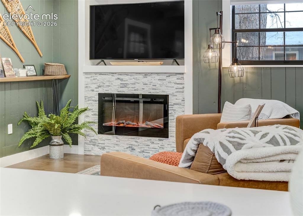 Image 8 of 49: The living room features a electric heating fireplace to enjoy on those col