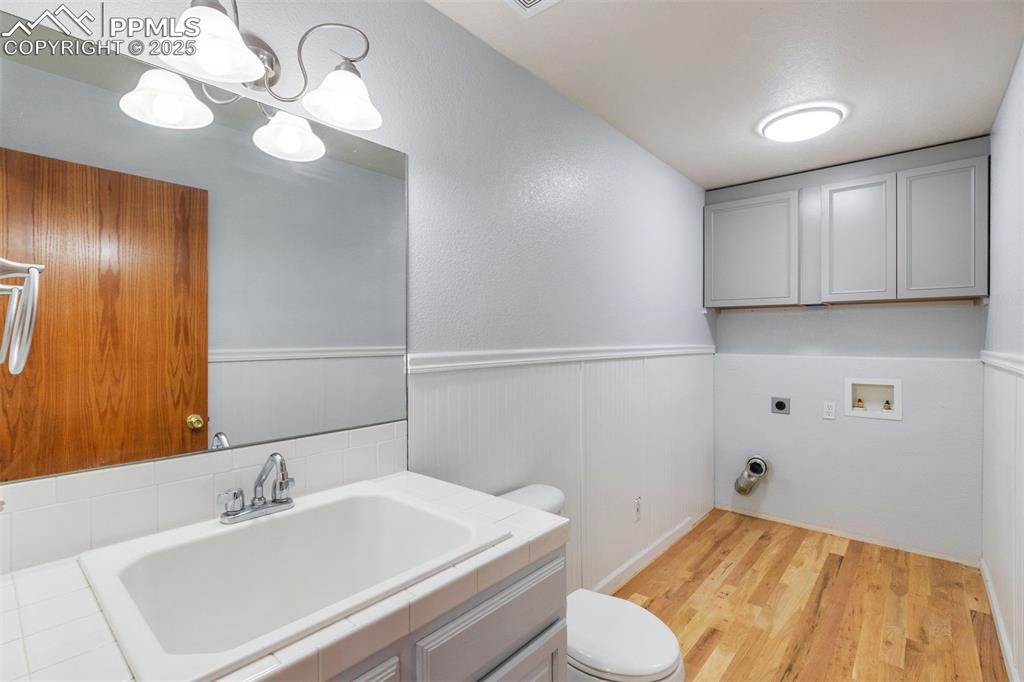 Image 21 of 41: Half bath and laundry room on main level