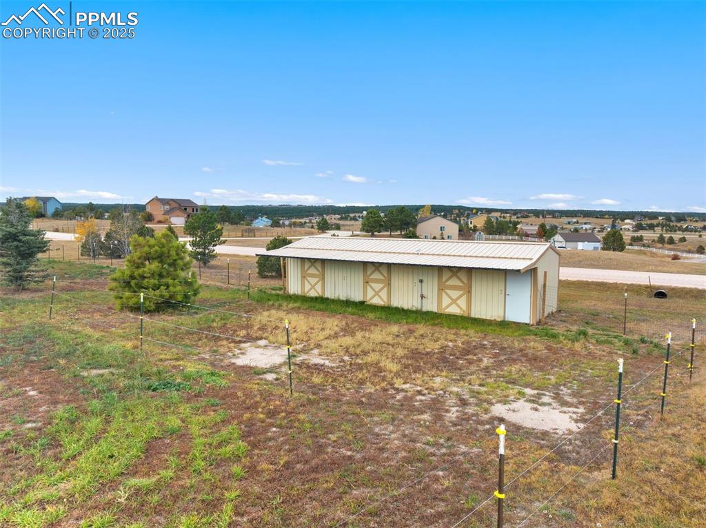 Image 34 of 41: Three horse barn with tack room and skylights