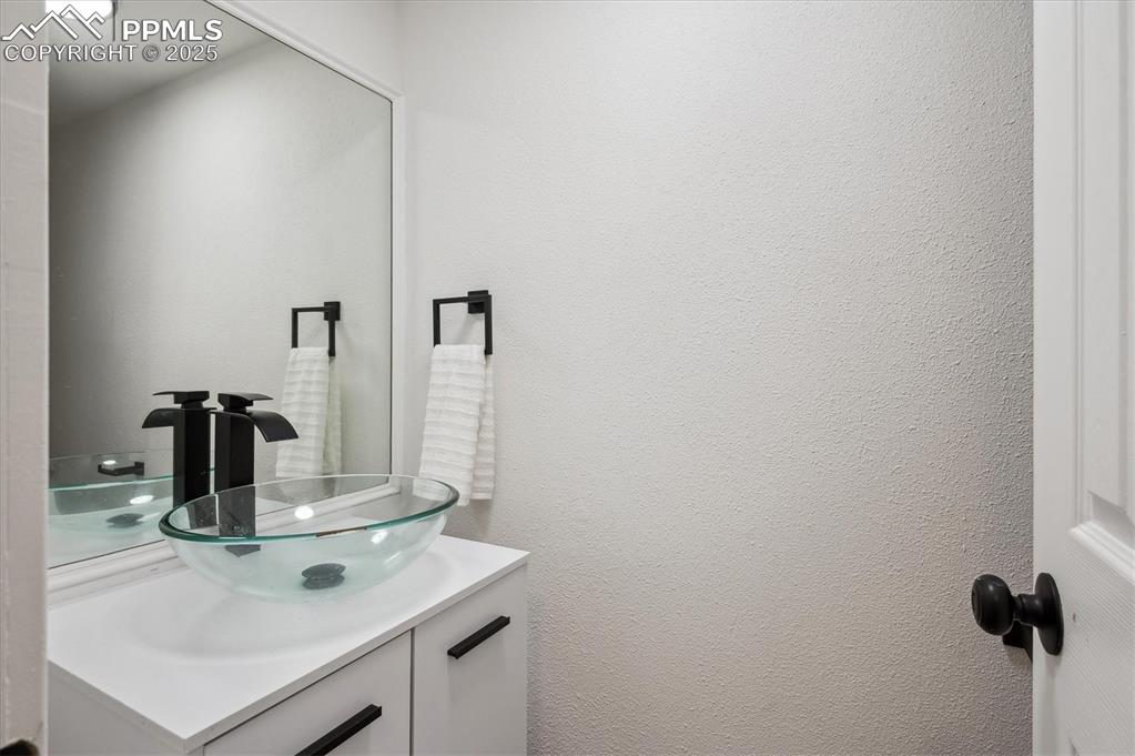 Image 13 of 44: Bathroom featuring vanity and a textured wall
