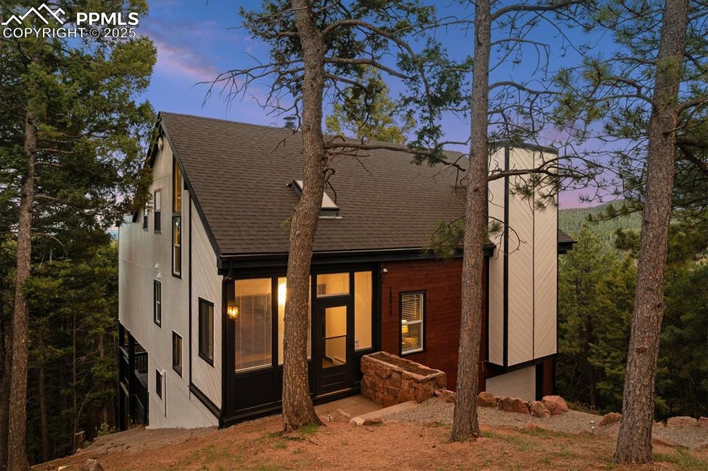 Image 38 of 44: View of front of property with roof with shingles and an attached garage