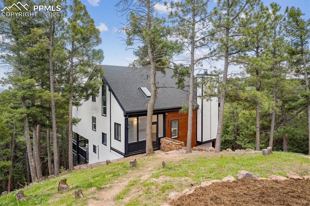 Image 4 of 44: View of front of house featuring a shingled roof