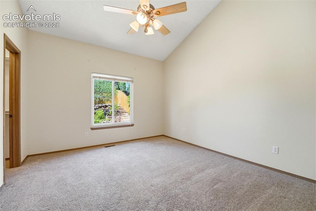 Image 10 of 30: Spacious room featuring vaulted ceilings, neutral-toned carpeting, a ceilin