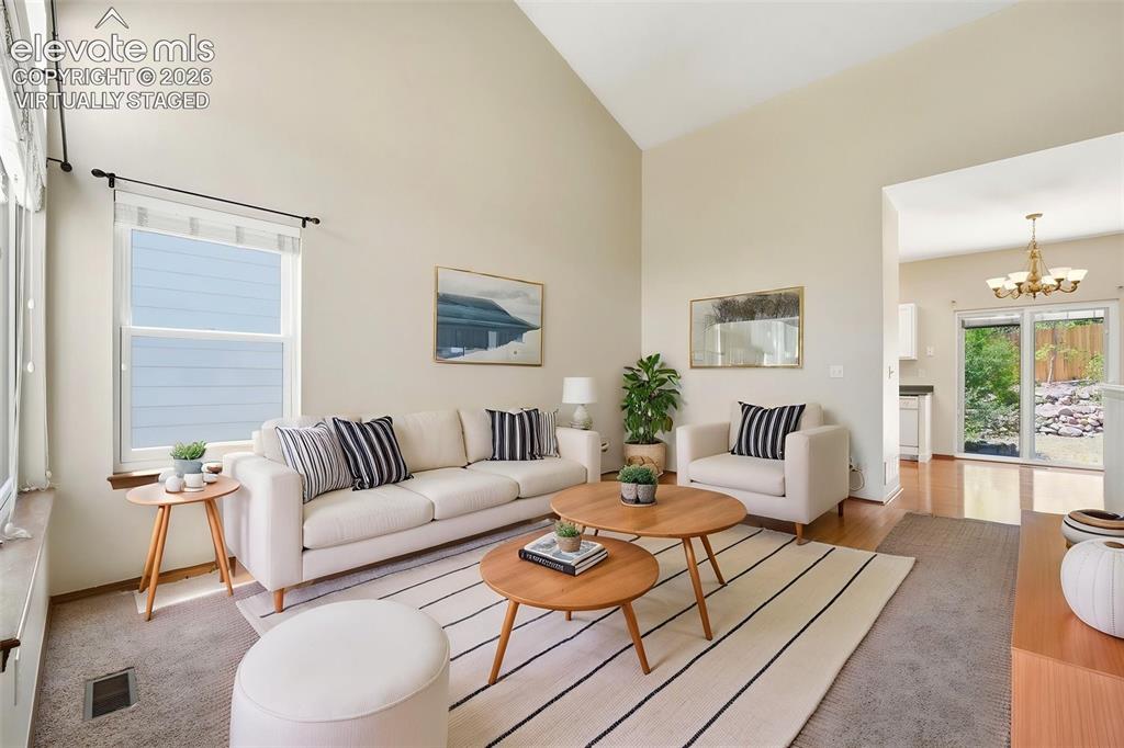 Image 3 of 30: (Virtually Staged) Open-concept living area featuring vaulted ceilings, abu