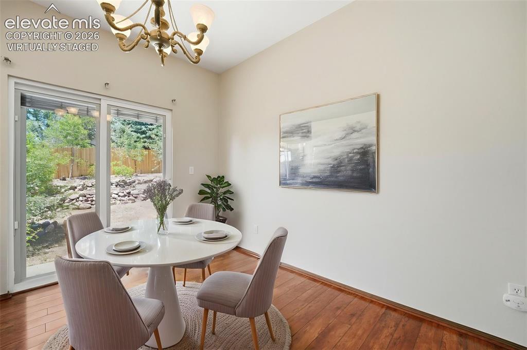 Image 7 of 30: (Virtually Staged) Dining area featuring wood-finish flooring, vaulted ceil