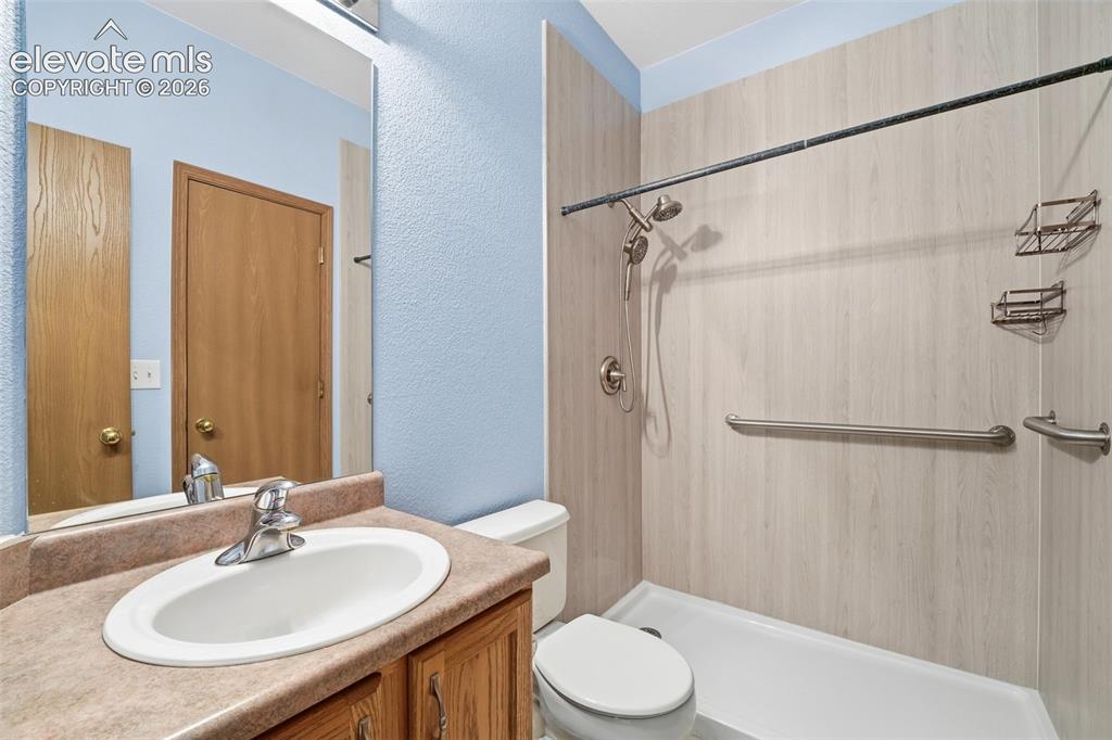 Image 9 of 30: Bathroom featuring a light blue wall finish, vanity with an oval sink, a wo