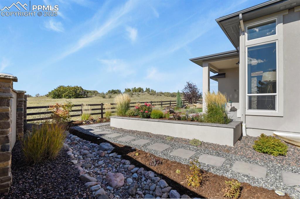 Image 43 of 50: Professionally landscaped and home backs to open space