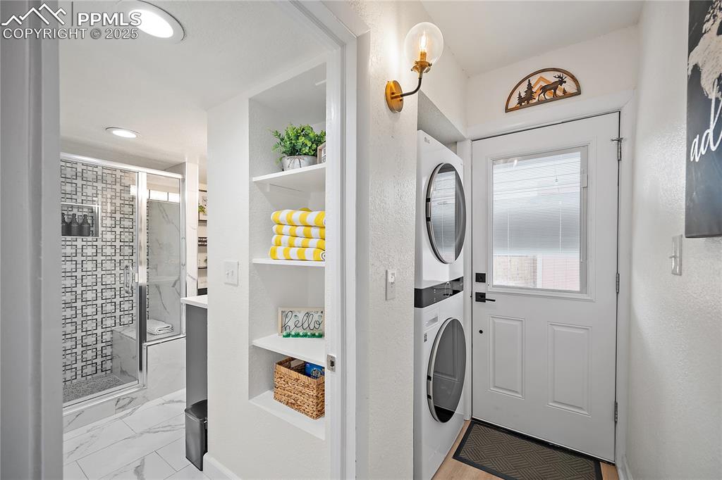 Image 15 of 47: Laundry area with laundry area, recessed lighting, marble finish floor, and