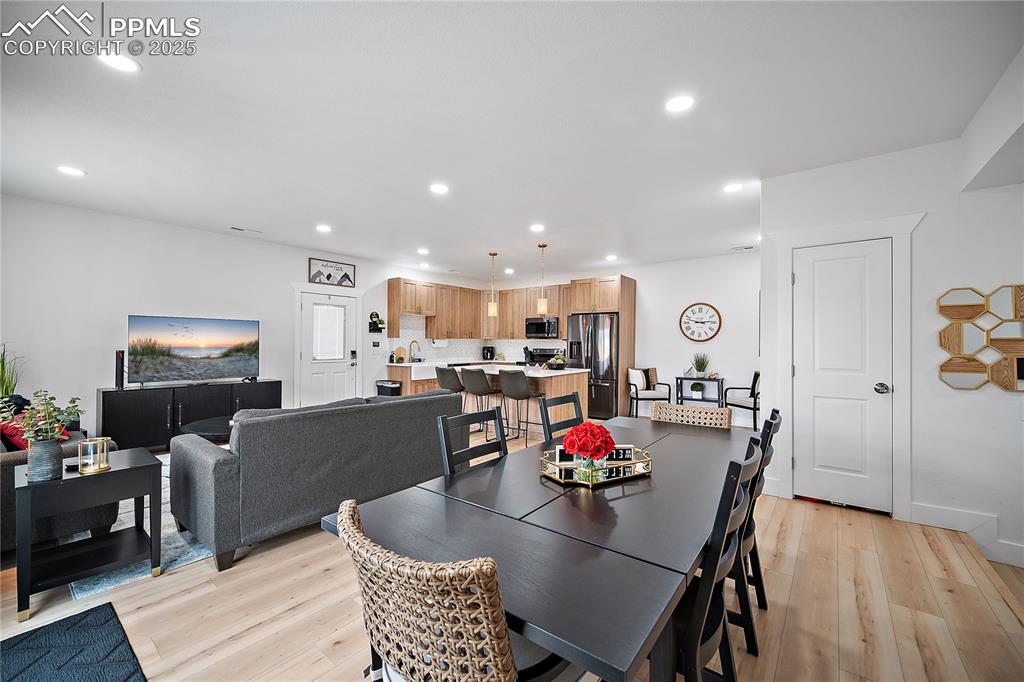 Image 28 of 47: Dining space featuring light wood-style floors and recessed lighting