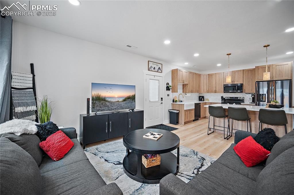 Image 31 of 47: Living room featuring recessed lighting and light wood-style flooring
