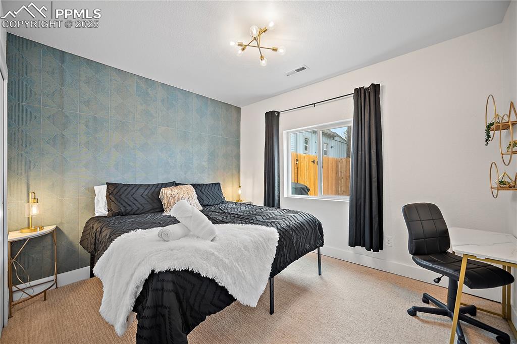 Image 33 of 47: Bedroom with visible vents, carpet flooring, and baseboards