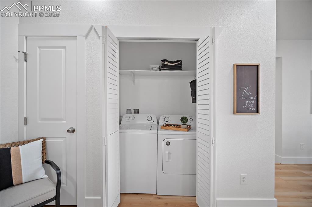 Image 37 of 47: Laundry area featuring laundry area, baseboards, light wood-style flooring,