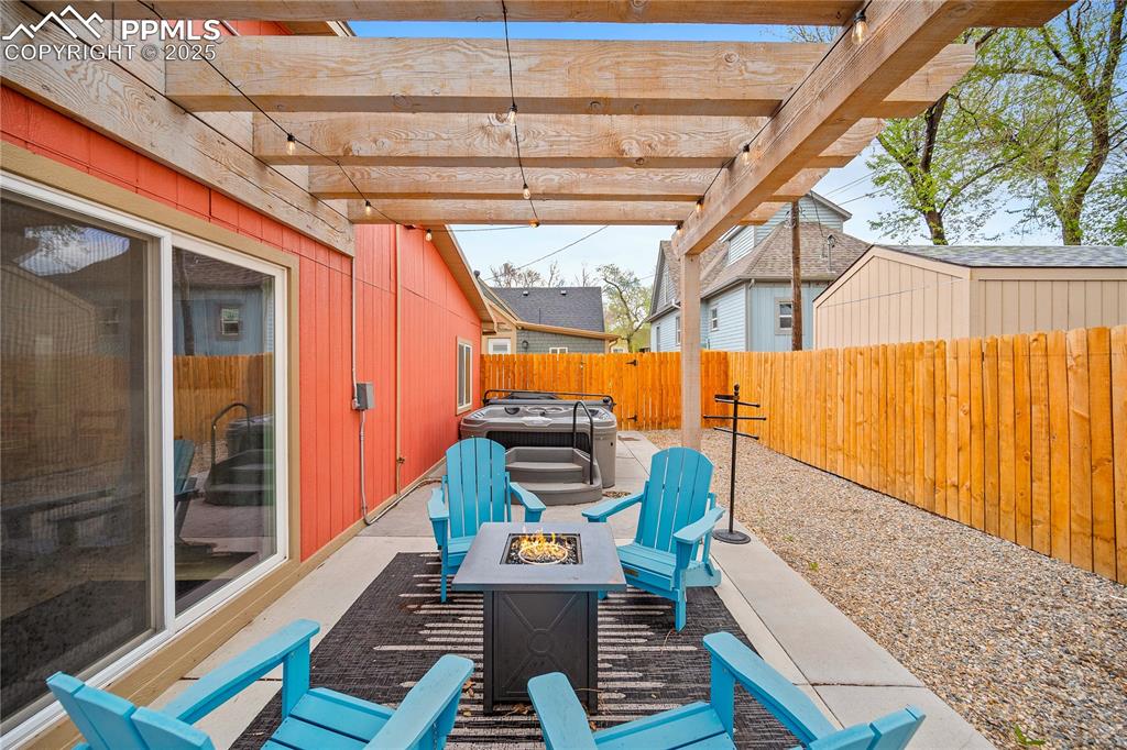 Image 38 of 47: View of patio featuring a fenced backyard and an outdoor fire pit