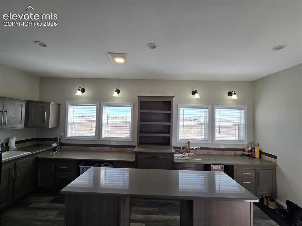 Image 22 of 25: Oversized laundry room with abundant space for storage, folding, organizing