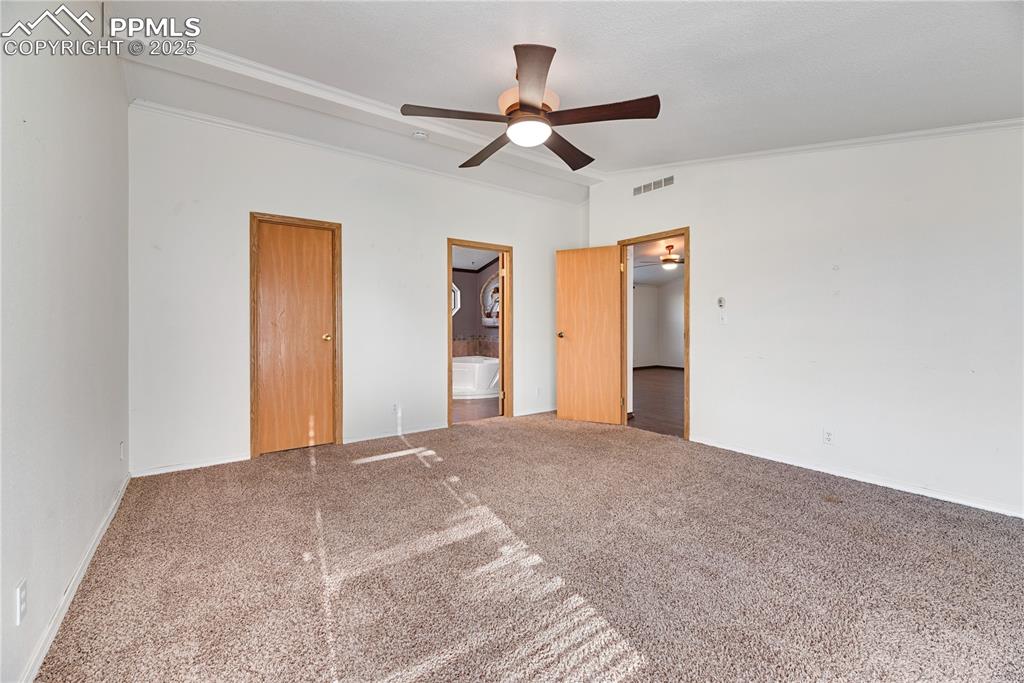 Image 16 of 46: Unfurnished bedroom featuring crown molding, carpet floors, vaulted ceiling