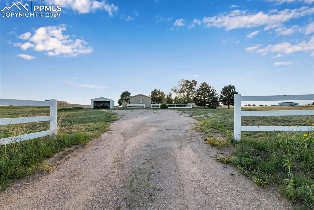 Image 3 of 46: View of dirt / gravel driveway with a water view and a rural view