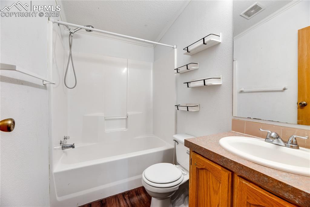 Image 31 of 46: Full bath with washtub / shower combination, vanity, wood finished floors,