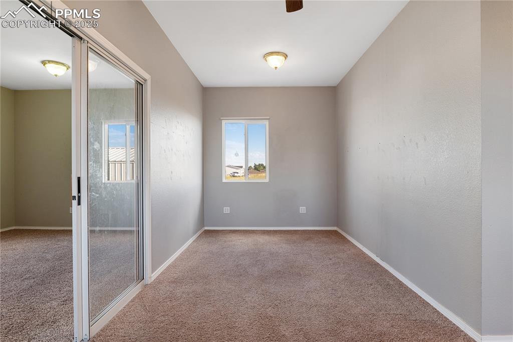 Image 36 of 46: Carpeted empty room with baseboards and a ceiling fan