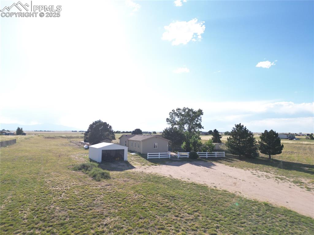 Image 40 of 46: View of yard with a view of rural / pastoral area, a pole building, and an
